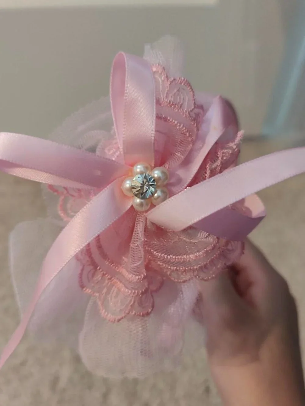 Pink lace headband with bow and pearl detail